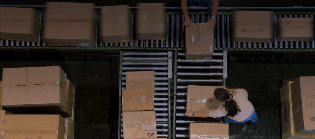 Manufacturing facility conveyor belt with cardboard boxes on it
